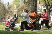 Kelly Valvuena and her son Kaden, 19 months, along with Amy Shumaker and son Cole, 2, work out one of several routines during a Stroller Burn session.