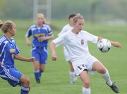 Lawrence High sophomore Olivia Dykes looks to push the ball up field against Olathe South during the first half, Monday, May 5, 2008 at YSI.