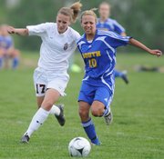 LHS sophomore Olivia Dykes, left, and Olathe South's Mackenzie Smith battle for position in the first half. Lawrence lost to Olathe South, 2-0, on Monday at YSI.