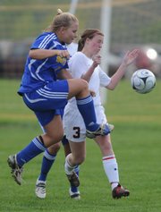 Lawrence High junior Becky Davis collides with Olathe South junior Kaylee Sextro during the first half, Monday, May 5, 2008 at YSI.