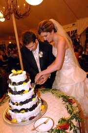 J.P. and Corey Marchetti cut her lemon-flavored wedding cake at their wedding reception catered by the contestants of Bravo&squot;s "Top Chef," a cooking reality show. The bride is a Lawrence native who was married in Chicago.