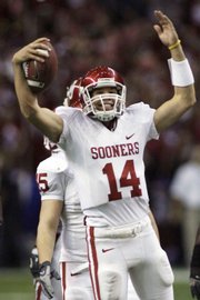 Oklahoma quarterback Sam Bradford (14) reacts in this file photo near the end of the Big 12 Conference championship game from Dec. 1, 2007. Bradford will orchestrate a high-octane offense in Norman this fall.