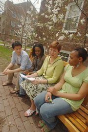 Jayne Niemi, second from right, registrar at Macalaster College in St. Paul, Minn., talks with students, from left, Baitnairamdal Otgonshar, from Mongolia, Nokuthula Sikhethiwe Kitikiti, from Zimbabwe, and Udochukwu Chinyere Obodo, from Nigeria, Tuesday at the campus. Niemi is responsible for pronouncing 450 names correctly at commencement ceremonies on May 17.