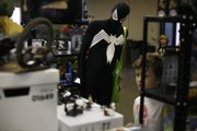 Karl Stratman, dressed as a version of Spider-Man, looks at a selection of Legos on Sunday during the Free State FreeCon Comic Book and Toy Convention at the Douglas County 4-H Fairgrounds.