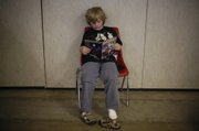 Treven Hall, 8, flips through a copy of Clockwork Girl on Sunday, May 18, 2008 while attending FreeCon at the Douglas County Fairgrounds.