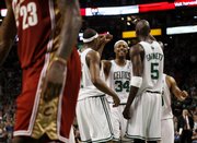 Boston's Paul Pierce (34) is congratulated by teammates Kevin Garnett (5) and James Posey during the fourth quarter of their 97-92 victory over the Cavaliers. Pierce had 41 points in the victory Sunday in Boston.