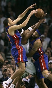 Detroit's Tayshaun Prince, left, and Rasheed Wallace, right, sandwich Boston's Paul Pierce. The Pistons defeated the Celtics, 103-97, on Thursday night in Boston to even the series at one game apiece.