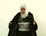 Iraqi Sajida al-Rishawi opens her jacket and shows an explosive belt as she confesses on Jordanian state-run television to her failed bid to set off an explosives belt inside one of the three Amman hotels in this file image made from television on Nov. 13, 2005. Women have carried out or attempted at least 20 suicide bombings since 2003 in the Iraq branch of al-Qaida.
