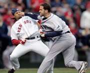 Tampa Bay pitcher James Shields, right, takes a swing at Boston's Coco Crisp after Crisp was hit by a pitch and charged the mound in the second inning. The Red Sox ended up defeating the Rays, 7-1, on Thursday in Boston.