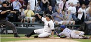 umpire Chris Tiller, left, calls Chicago's Jim Thome safe as Kansas City's Alberto Callaspo, right, looks on. The White Sox beat the Royals, 6-2, Thursday in Chicago.