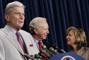 Sen. Joseph Lieberman, D-Conn., center, and Sen. Barbara Boxer, D-Calif., right, talk Friday in Washington as Sen. John Warner, R-Va., left, speaks during a news conference to discuss the environment and climate change.