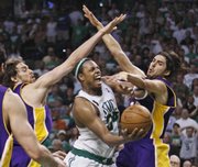 Boston's Paul Pierce, center, tries to scoop a shot between Pau Gasol, left, and Sasha Vujacic. The Celtics beat the Lakers, 108-102, Sunday in Boston.