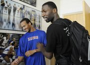 Former KU basketball player and current member of the New Orleans Hornets, Julian Wright, right, greets KU freshman Travis Releford, left, before Wright was introduced at the Bill Self Kansas Basketball Camp Tuesday, June 10, 2008.
