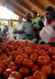 Crowds of people line up to buy Arkansas-grown tomatoes at the Farmers Market Saturday in Little Rock, Ark. Because Arkansas tomatoes have not been linked to the recent salmonella outbreak, Arkansas tomato growers say they are seeing a boost in sales.