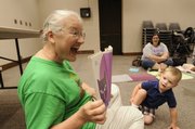 Linda Clay, children's library assistant for the Lawrence Public Library, reads to toddlers, including Joey Prisinzano, 2, during the Wednesday morning Books and Babies Storytime. Visit Lawrence Public Library's Web site, www.lawrence.lib.ks.us, for more storytimes.