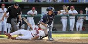 Fresno State's Steve Susdorf scores on a base hit by Tommy Mendonca, as North Carolina catcher Tim Federowicz, right, waits for the ball. Fresno State ousted UNC from the College World Series, 6-1, Sunday in Omaha, Neb.