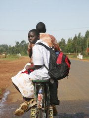 A schoolgirl rides on bicycle taxi in Bungoma, Kenya. Schoolchildren have been targeted and seized by rebel militias, and then thrown into torture centers during an army crackdown in the Mount Elgon area.
