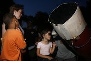 Six-year-old Sammi Dunham takes a closer look at Saturn during an Astronomy Associates of Lawrence public viewing June 25 at South Park.