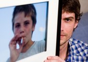 Photographer Maarten Dors shows his picture of a Romanian child smoking a cigarette entitled "The Romanian Way" at his home in Enschede, Netherlands. Without notice, Yahoo deleted the photo from its photo-sharing service, Flickr, on the grounds it violated an unwritten ban on depicting children smoking.