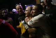 Mark Sears, center, is congratulated after he won a recent bout at Coyote's. Yoder, a co-worker and friend of Sears' who fought later that night, is at right.