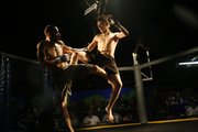 Joe Stark, right, leaps at Lance Yoder as their cage fight begins on a recent Friday at Coyote's nightclub, near 23rd Street and Haskell Avenue. Cage fighting, also called Mixed Martial Arts, is gaining popularity across the country and in Lawrence.