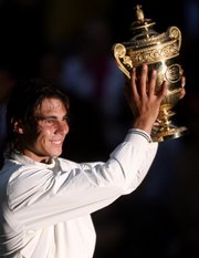Spain's Rafael Nadal holds his trophy aloft after defeating Switzerland's Roger Federer in the men's singles final. Nadal denied Federer a record sixth-straight Wimbledon title on Centre Court on Sunday in Wimbledon, England.