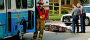 Lawrence police and paramedics work the scene of a fatality accident near Sixth and Arkansas streets Saturday afternoon. A moped driver was killed in a collision with a T bus around 5 p.m.