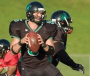 Jason Sutherland, a former standout University of Missouri basketball player, looks for a receiver in the Kansas Kaos' 34-0 victory over the Cass County Renegades in this photo from June 28 in Bonner Springs. Sutherland is the minor-league football team's starting quarterback.