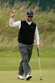 David Duval gestures from the 18th green during the second round of the British Open. Duval, who won the championship in 2001, shot a 1-under 69 on Friday to leave him three strokes off the lead.
