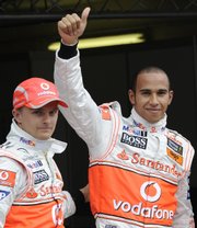 Lewis Hamilton, right, celebrates next to third-place teammate Heikki Kovalainen on Saturday in Hockenheim, Germany.