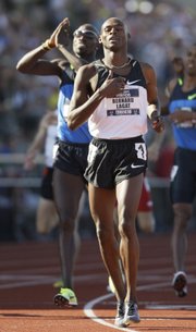 In this July 6 file photo, Bernard Lagat, right, crosses the finish line ahead of Lopez Lomong to win the men's 1,500-meter final at the U.S. Olympic Track and Field Trials in Eugene, Ore.