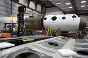 Workers in Mojave, Calif., prepare the "mothership," an aircraft that will launch a commercial spaceship some 62 miles above Earth. British billionaire Sir Richard Branson and American aerospace designer Burt Rutan are due Monday to show off this mothership called White Knight Two.