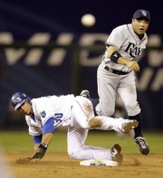 Tampa Bay second baseman Akinori Iwamura, right, and Kansas City shortstop Mike Aviles watch as Iwamura throws to first in an unsuccessful double-play attempt Saturday in Kansas City, Mo.