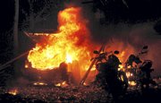 Flames rise out of burning vehicles at the site of an explosion Saturday in Ahmadabad, India. At least 16 bombs went off Saturday evening in several crowded neighborhoods of Ahmadabad, killing 29 people.