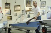 Bruce Liese, owner of Kansas City Sailing at 725 N. Second St., sets up a Laser, one of the type of boats to be featured in the Summer Olympics.