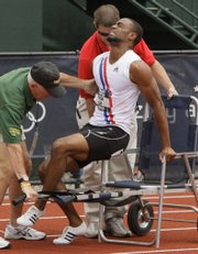 Tyson Gay is helped to a wheelchair after falling during a quarterfinal heat of the men's 200-meter race July 5 at the U.S. Olympic Track and Field Trials in Eugene, Ore.
