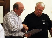 Jim Flory, left, shakes hands with John Tacha at the Douglas County Courthouse Tuesday night after the results were in and Flory claimed victory.