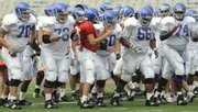 Kansas quarterback Todd Reesing and his offensive line from left, Matt Darton, Chet Hartley, Ryan Cantrell, Adrian Mayes and Jeff Spikes, break from the huddle at open practice on Friday at Memorial Stadium. Kansas coach Mark Mangino named Spikes, who will replace departed left tackle Anthony Collins, the starter for the 2008 season at left tackle.
