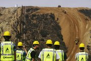 A U.S. construction crew works Friday to fill the Smuggler's Gulch near the U.S.-Mexico border in San Diego. Scrapers and bulldozers began filling the deep canyon Friday to make way for a border fence in the southwestern corner of the continental United States after 12 years of planning, environmental reviews and legal challenges.