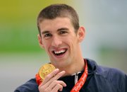 Michael Phelps shows his seventh gold medal after the men's 100-meter butterfly final today in Beijing.