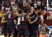 Kobe Bryant, top right, leaps on his U.S. men's basketball teammates after the gold-medal game at the Olympics. The U.S. men won the gold Sunday in Beijing.