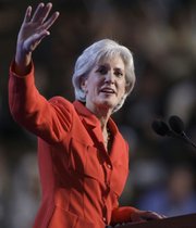 Kansas Gov. Kathleen Sebelius waves as she gets ready to address the Democratic National Convention in Denver. Sebelius used her time on the national stage Tuesday to attack Republican candidate John McCain's "country club economics."