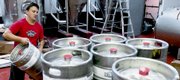 Brewer Geoff Deman stacks freshly washed kegs on a forklift Wednesday at the Free State Brewery production facility, 1923 Moodie Road. As the price of stainless steel climbs, thieves are cashing in by selling the kegs for scrap.