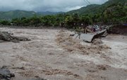 Residents stand on what remains of a collapsed bridge that was destroyed by Hurricane Gustav on Friday in Kingston, Jamaica. Deadly Gustav drenched Jamaica and plowed through the Cayman Islands on Friday, and on the anniversary of Hurricane Katrina's landfall, forecasters said for the first time there's a better-than-even chance that New Orleans will get slammed by tropical storm-force winds.