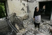 Ethnic Georgian Oliya Gudadze, 68, camps in the ruins of her house in Ksuisi village east from Tskhinvali, near the South Ossetian-Georgian border in Georgia. Gudadze said she hid in a corn field as Russian troops swept through, then watched as her neighbors descended on her home, looted it and set it on fire. Arson gangs have targeted the homes of ethnic Georgians in breakaway South Ossetia as the conflict threatens to erase a centuries-old ethnic mix.