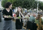 Jennifer Matz, left, and Kristin Cohen serve at the opening dinner of Slow Food Nation outside City Hall in San Francisco on Thursday.