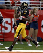 Missouri wide receiver Jeremy Maclin quiets the crowd after returning a kickoff 99 yards for a touchdown. Missouri beat Illinois, 52-42, on Saturday night in St. Louis.