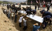 Georgian honor guard soldiers lower coffins into the ground at a funeral ceremony of Georgian soldiers killed during the Georgian-Russian war in Tbilisi, Georgia, on Saturday. Georgia has severed diplomatic ties with Moscow to protest the presence of Russian troops on its territory.
