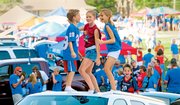 Young Jayhawk fans dance on top of a car before Kansas University's first football game of the season Saturday in Memorial Stadium. Cars were filling the stadium's parking lots Saturday afternoon before KU played against Florida International on Saturday night. The Jayhawks won 40-10 in front of a record crowd of 52,112 fans.