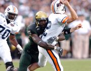 USF defensive end George Selvie hits UT Martin quarterback Cade Thompson in this Aug. 30 file photo in Tampa, Fla. Selvie, who led the country in tackles for loss last year, will look to give KU fits on Friday.